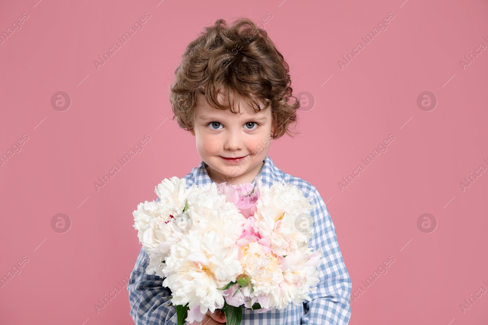 Cute little boy with bouquet of beautiful peonies on pink background Photo of Cute little boy with bouquet of beautiful peonies on pink background