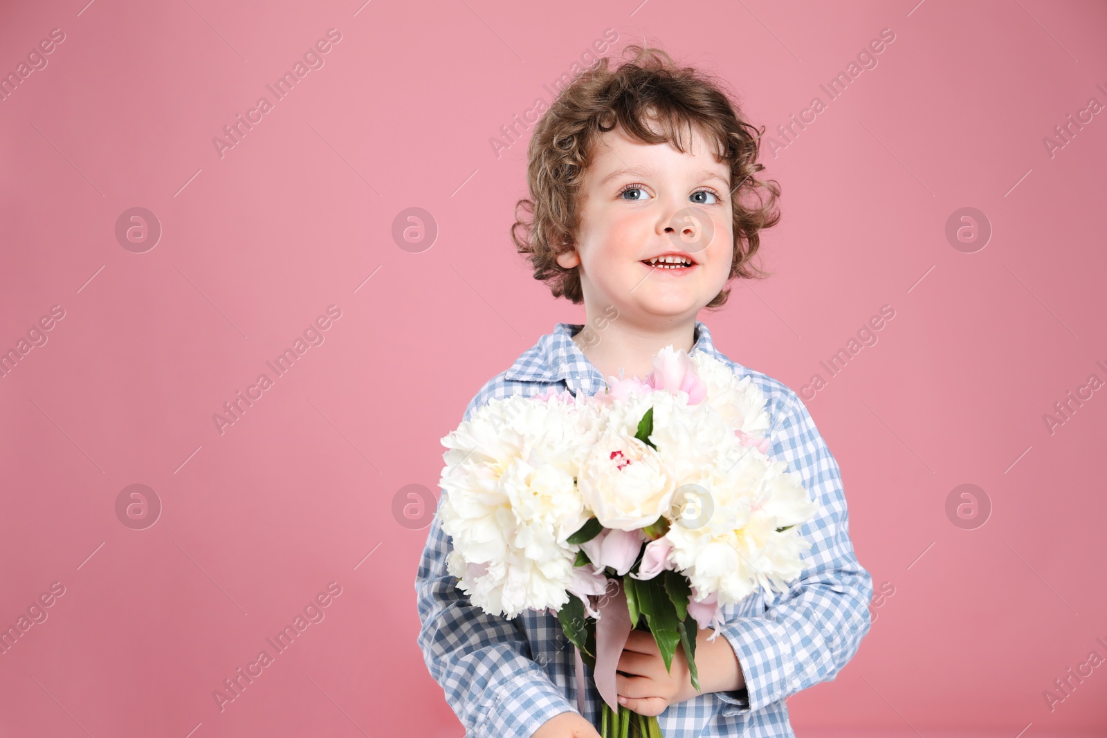 Cute little boy with bouquet of beautiful peonies on pink background. Space for text Photo of Cute little boy with bouquet of beautiful peonies on pink background. Space for text