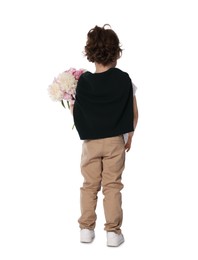Photo of Cute little boy with bouquet of beautiful peonies on white background, back view
