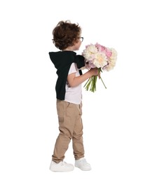 Photo of Cute little boy with bouquet of beautiful peonies on white background