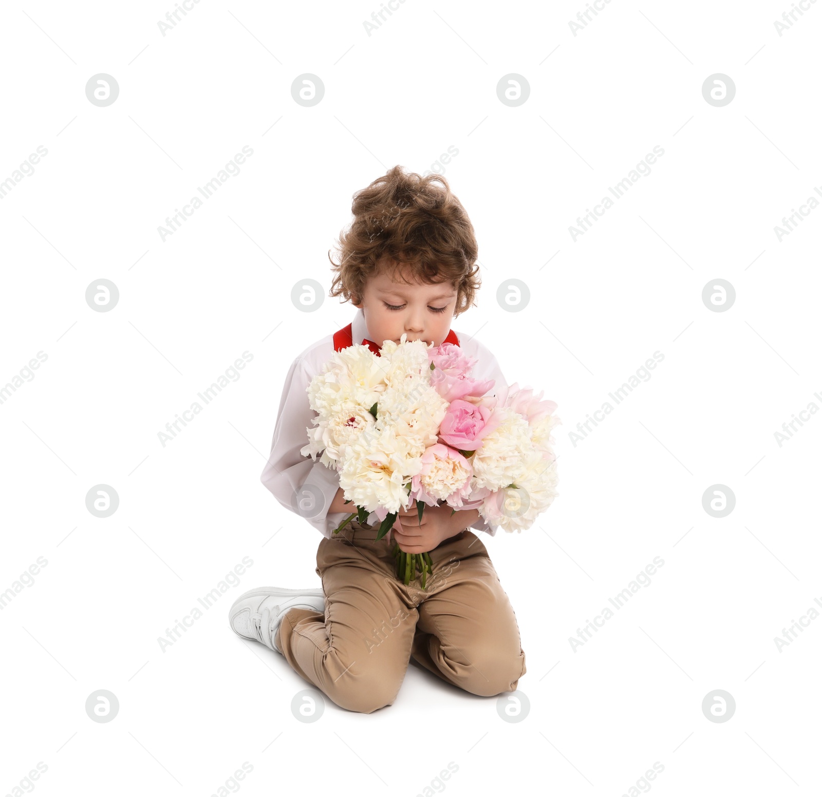 Cute little boy with bouquet of beautiful peonies on white background Photo of Cute little boy with bouquet of beautiful peonies on white background