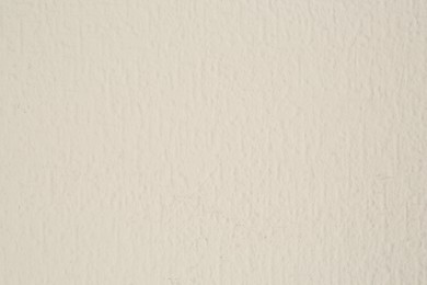 Photo of Beige textured surface as background, closeup view