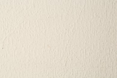 Photo of Beige textured surface as background, closeup view