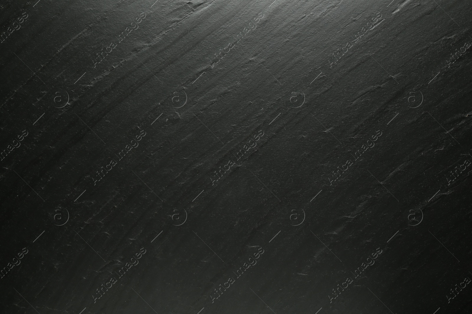 Photo of Black textured surface as background, closeup view