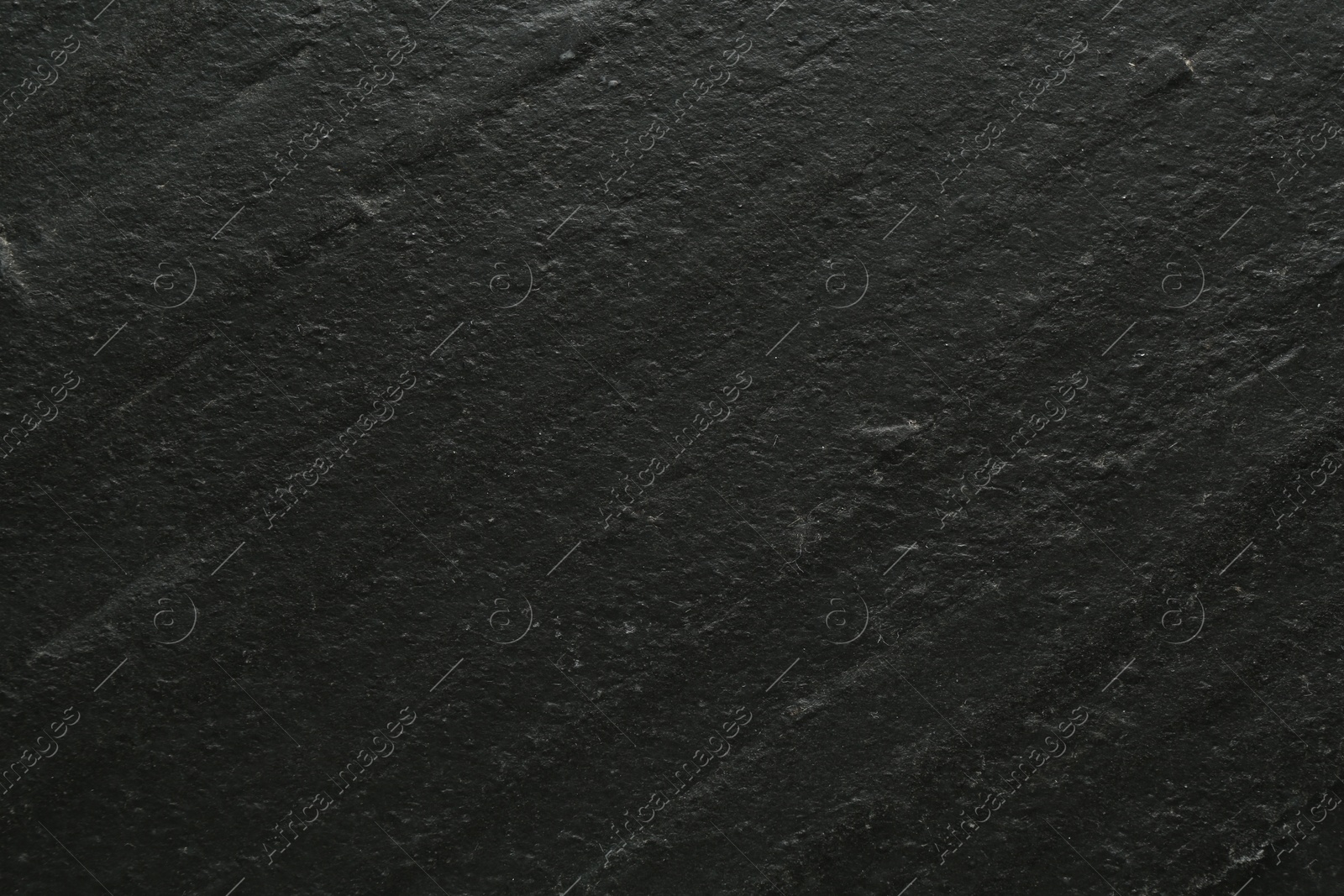 Black textured surface as background, closeup view Photo of Black textured surface as background, closeup view