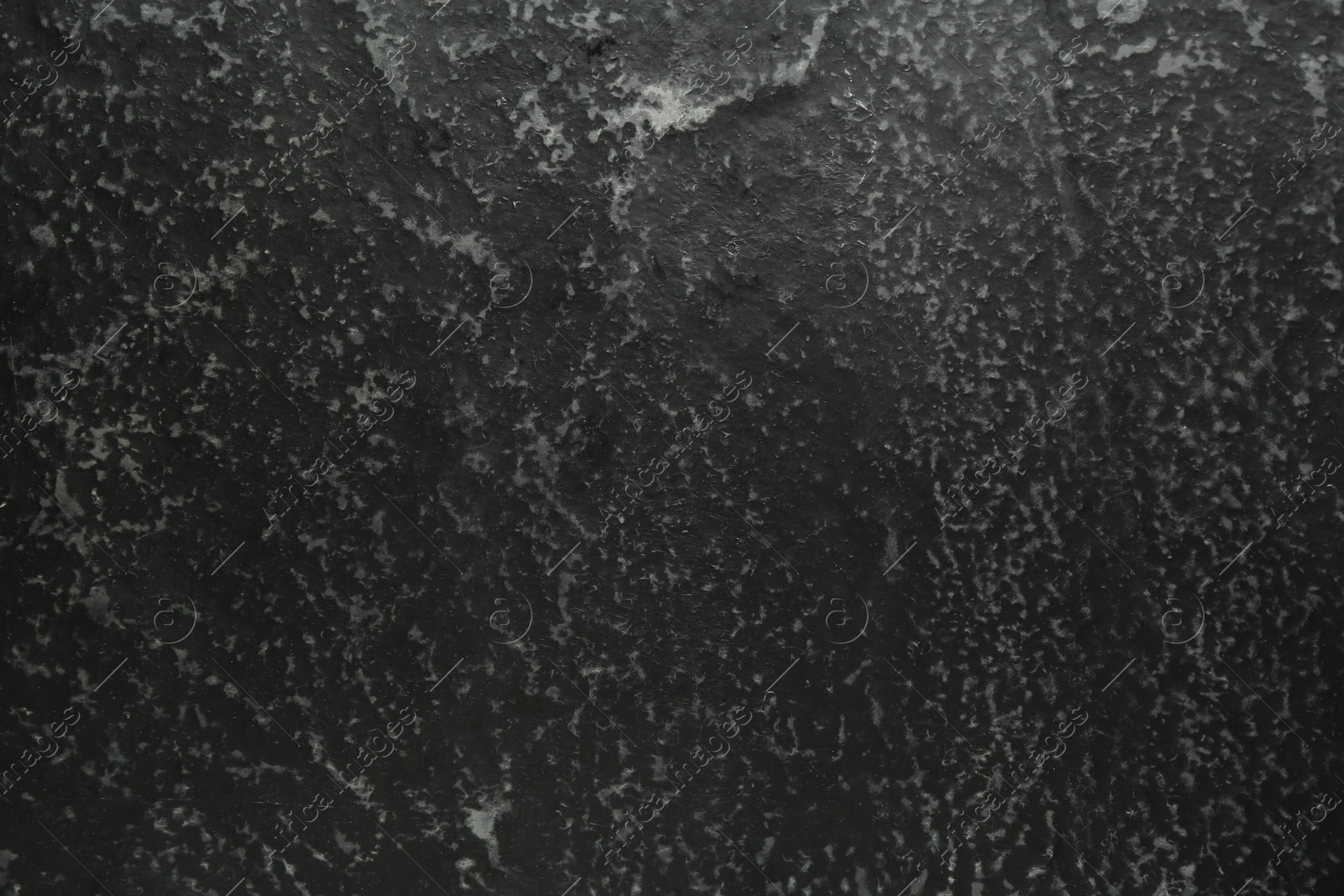 Black textured surface as background, closeup view Photo of Black textured surface as background, closeup view