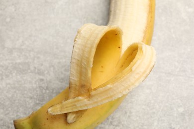 Photo of Banana with heart made of peel on grey table, above view