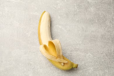 Photo of Banana with heart made of peel on grey table, top view