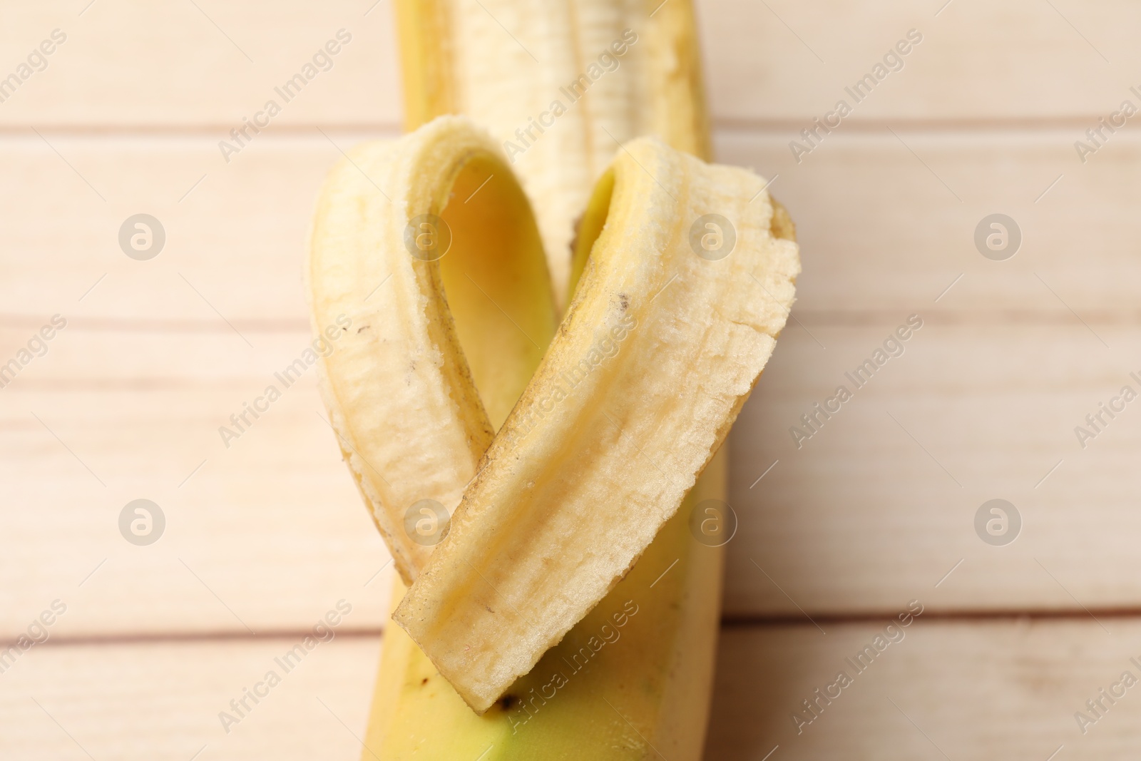 Banana with heart made of peel on wooden table, closeup Photo of Banana with heart made of peel on wooden table, closeup