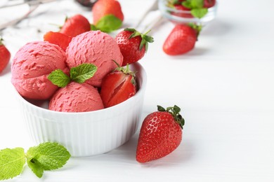 Photo of Tasty sorbet with strawberries and mint served on white wooden table, closeup. Space for text