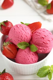 Photo of Tasty sorbet with strawberries and mint served on white wooden table, closeup