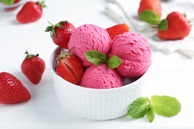 Photo of Tasty sorbet with strawberries and mint served on white wooden table, closeup