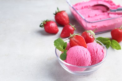 Photo of Tasty sorbet with strawberries and mint served on light table, closeup. Space for text
