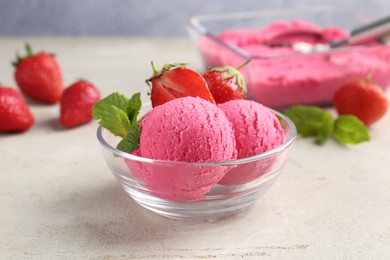 Photo of Tasty sorbet with strawberries and mint served on light table, closeup