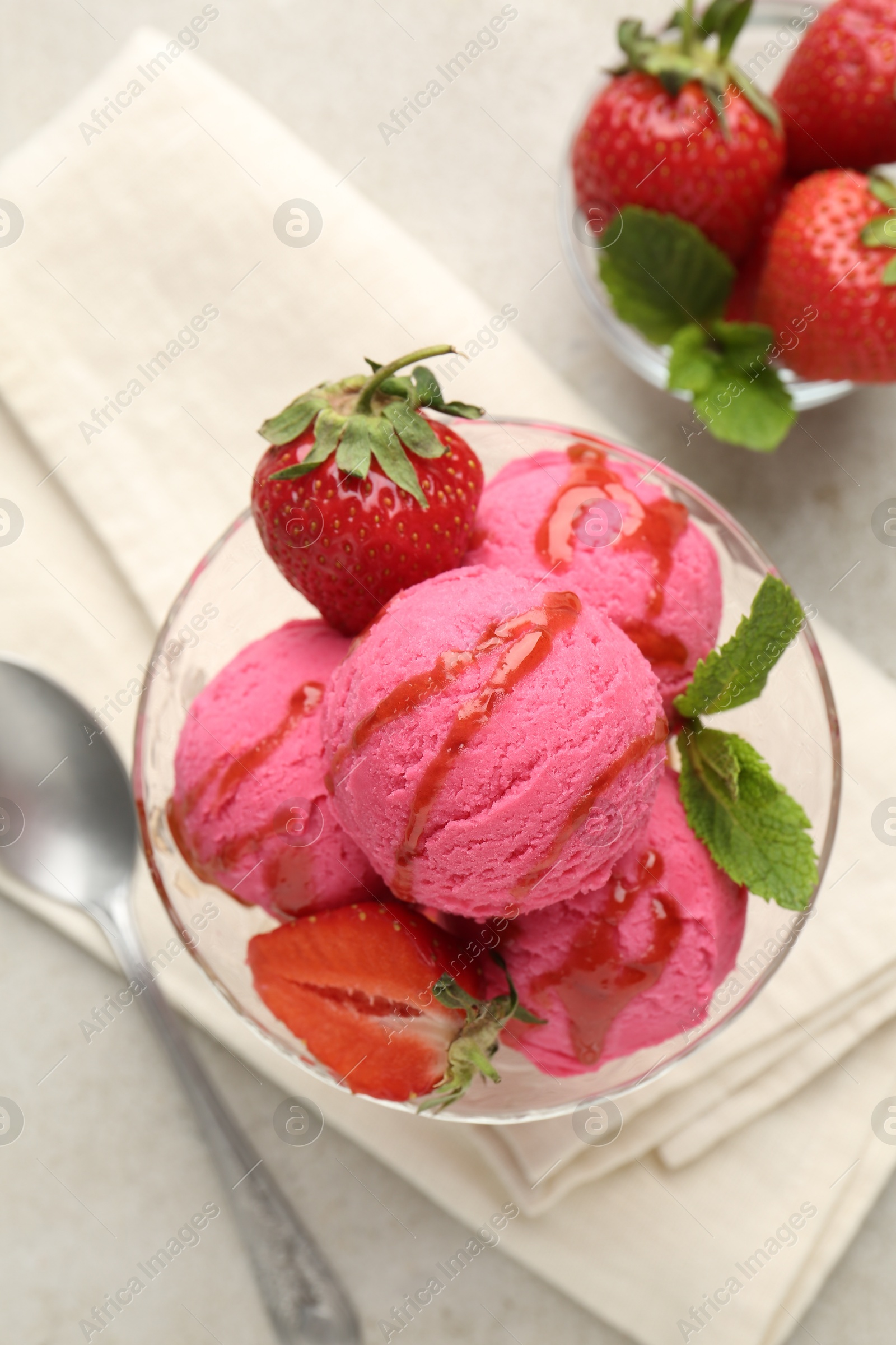 Photo of Tasty sorbet with strawberries and mint served on light table, flat lay