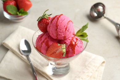 Photo of Tasty sorbet with strawberries and mint served on light table, closeup