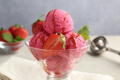 Photo of Tasty sorbet with strawberries and mint served on light table, closeup
