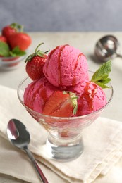 Photo of Tasty sorbet with strawberries and mint served on light table