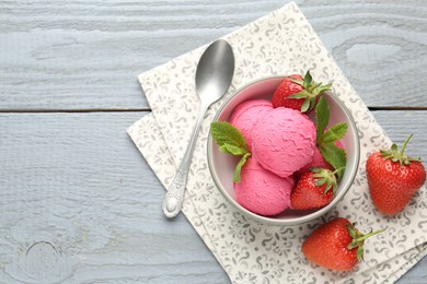 Photo of Tasty sorbet with strawberries and mint served on grey wooden table, flat lay. Space for text