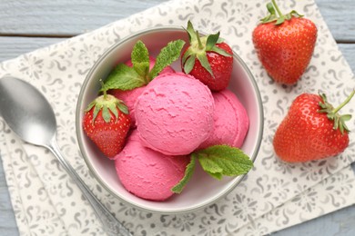 Photo of Tasty sorbet with strawberries and mint served on grey wooden table, flat lay