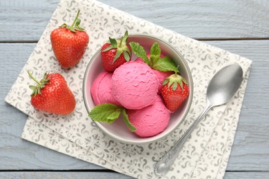 Photo of Tasty sorbet with strawberries and mint served on grey wooden table, flat lay
