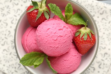 Photo of Tasty sorbet with strawberries and mint served on table, top view