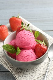 Photo of Tasty sorbet with strawberries and mint served on grey wooden table, closeup