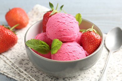 Photo of Tasty sorbet with strawberries and mint served on grey wooden table, closeup