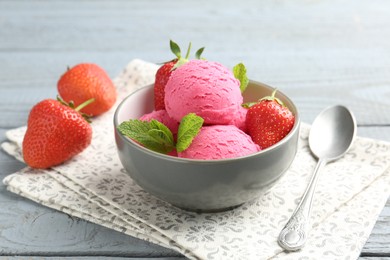Photo of Tasty sorbet with strawberries and mint served on grey wooden table, closeup