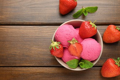 Photo of Tasty sorbet with strawberries and mint served on wooden table, flat lay. Space for text