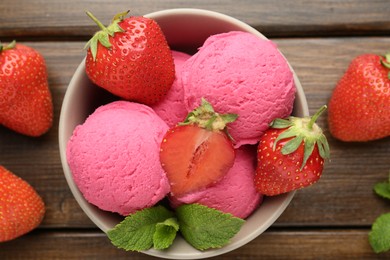Photo of Tasty sorbet with strawberries and mint served on wooden table, flat lay