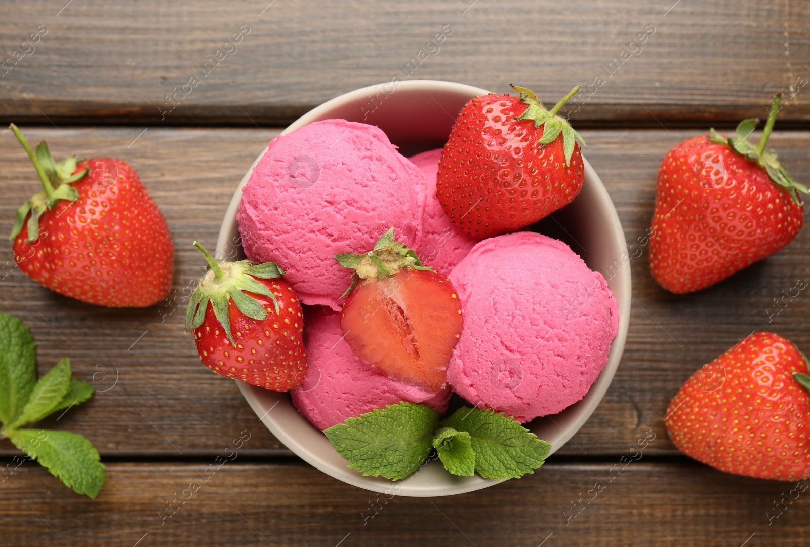 Tasty sorbet with strawberries and mint served on wooden table, flat lay Photo of Tasty sorbet with strawberries and mint served on wooden table, flat lay