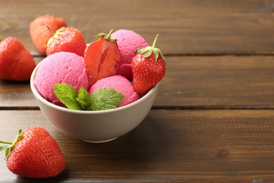 Photo of Tasty sorbet with strawberries and mint served on wooden table, closeup. Space for text