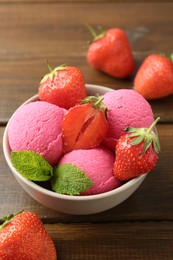 Photo of Tasty sorbet with strawberries and mint served on wooden table, closeup
