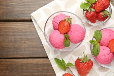 Photo of Tasty sorbet with strawberries and mint served on wooden table, flat lay. Space for text