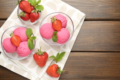 Photo of Tasty sorbet with strawberries and mint served on wooden table, flat lay. Space for text