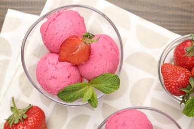 Photo of Tasty sorbet with strawberries and mint served on wooden table, flat lay