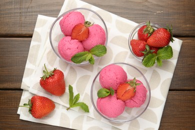 Photo of Tasty sorbet with strawberries and mint served on wooden table, flat lay