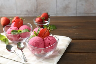 Photo of Tasty sorbet with strawberries and mint served on wooden table. Space for text
