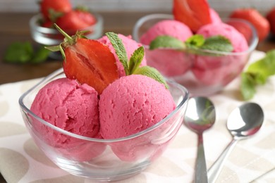 Photo of Tasty sorbet with strawberries and mint served on wooden table, closeup