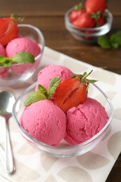 Photo of Tasty sorbet with strawberries and mint served on wooden table, closeup