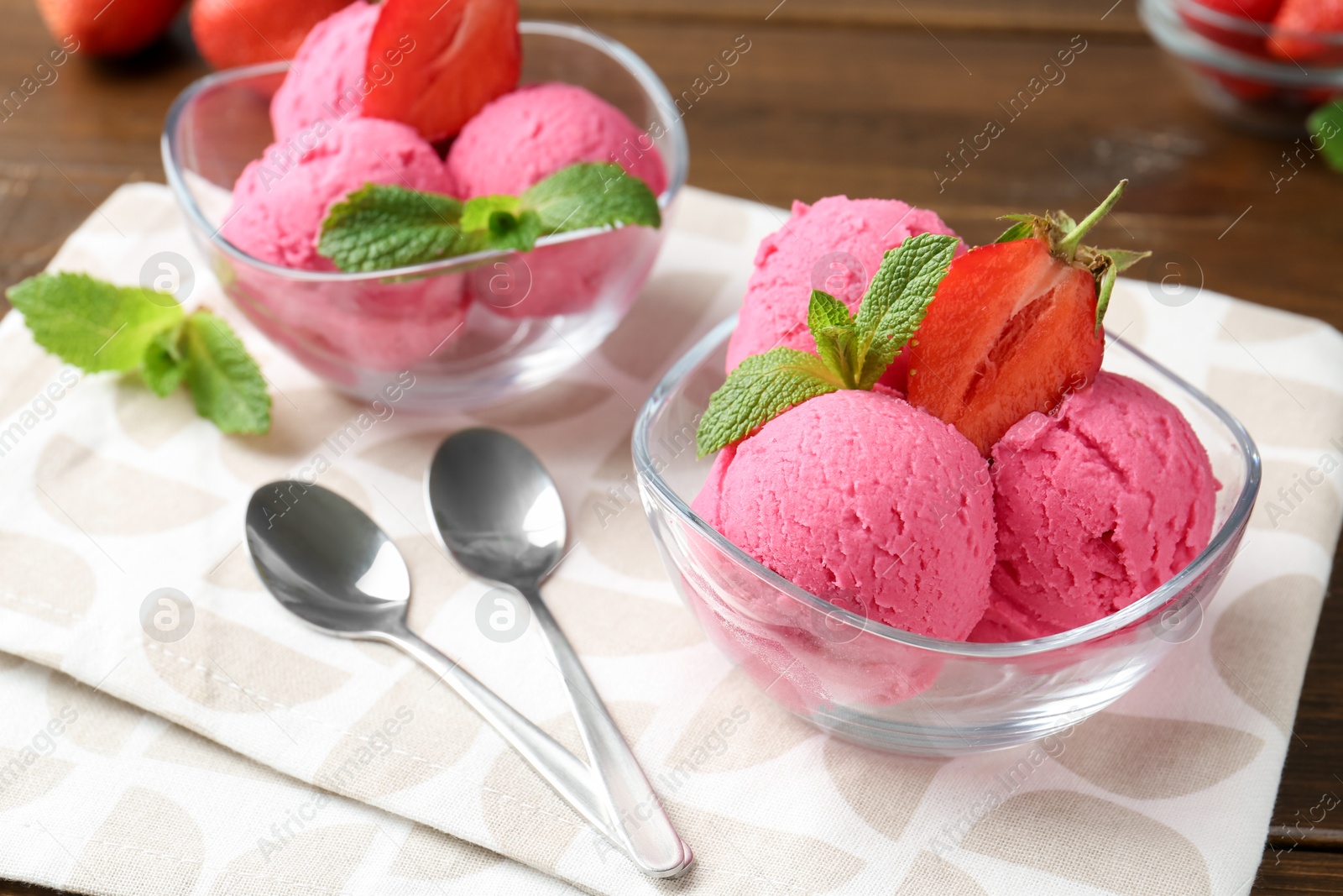 Tasty sorbet with strawberries and mint served on wooden table, closeup Photo of Tasty sorbet with strawberries and mint served on wooden table, closeup