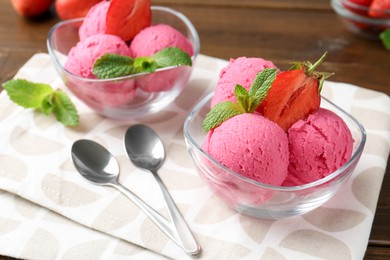 Photo of Tasty sorbet with strawberries and mint served on wooden table, closeup