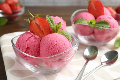 Photo of Tasty sorbet with strawberries and mint served on wooden table, closeup