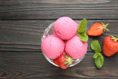 Photo of Tasty sorbet with strawberries and mint served on wooden table, flat lay. Space for text