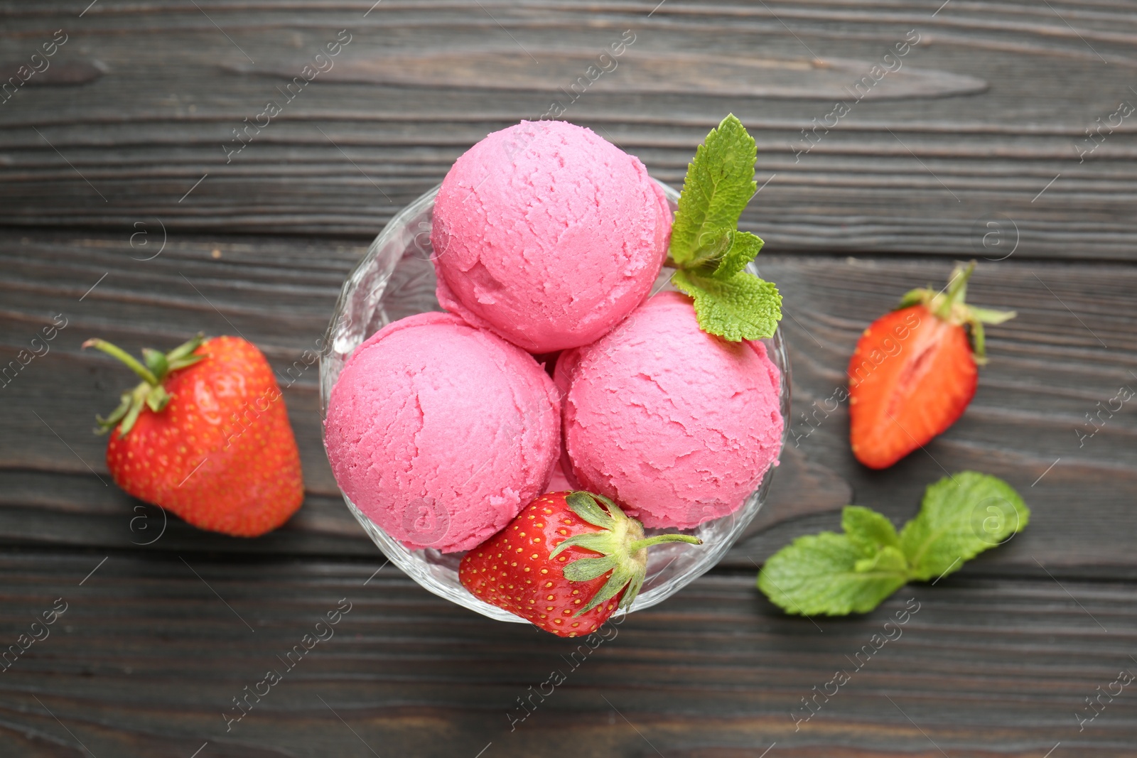 Tasty sorbet with strawberries and mint served on wooden table, flat lay Photo of Tasty sorbet with strawberries and mint served on wooden table, flat lay