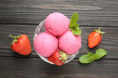 Photo of Tasty sorbet with strawberries and mint served on wooden table, flat lay