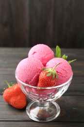 Photo of Tasty sorbet with strawberries and mint served on wooden table, closeup