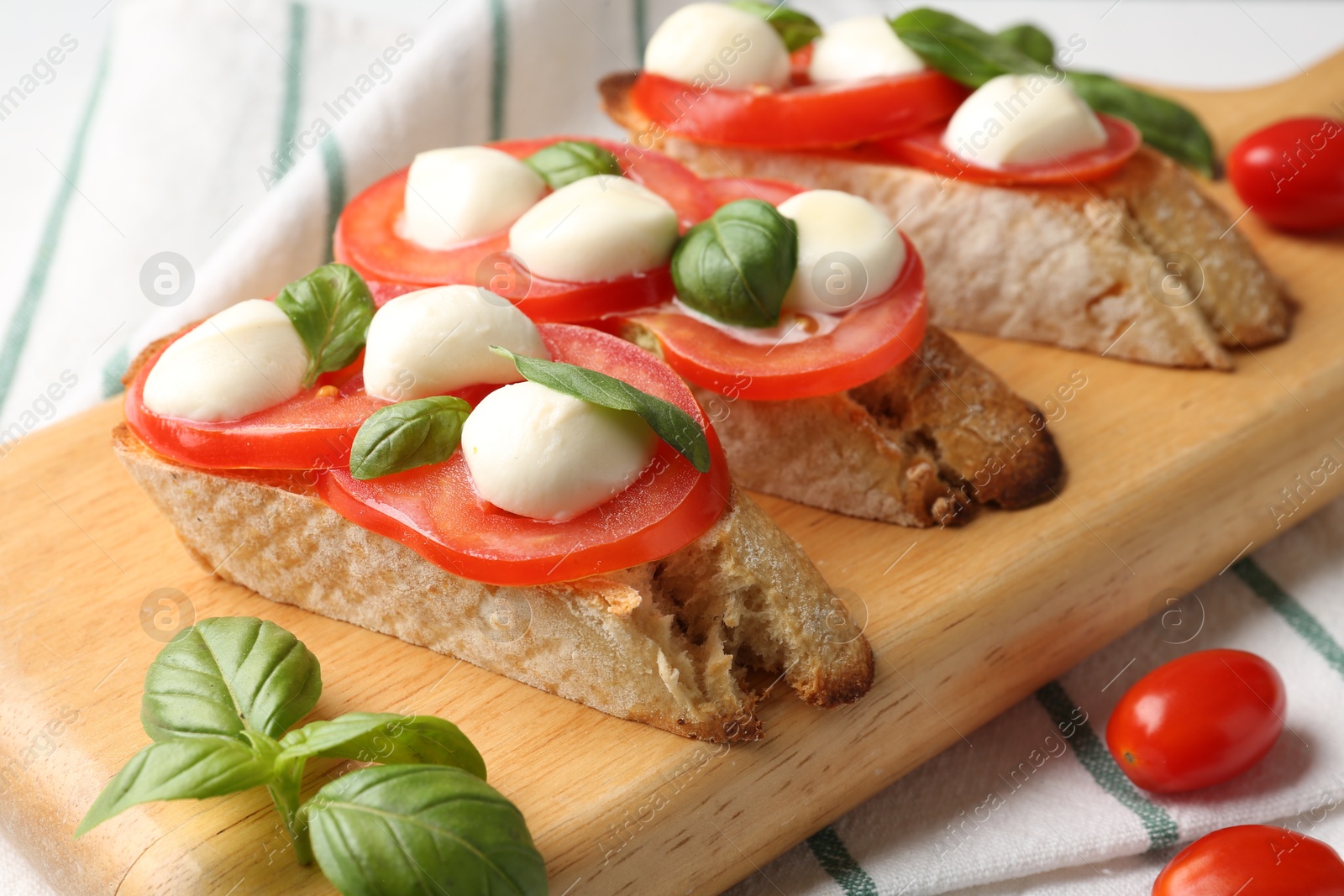 Tasty sandwiches with mozzarella cheese, tomatoes and basil on table, closeup Photo of Tasty sandwiches with mozzarella cheese, tomatoes and basil on table, closeup