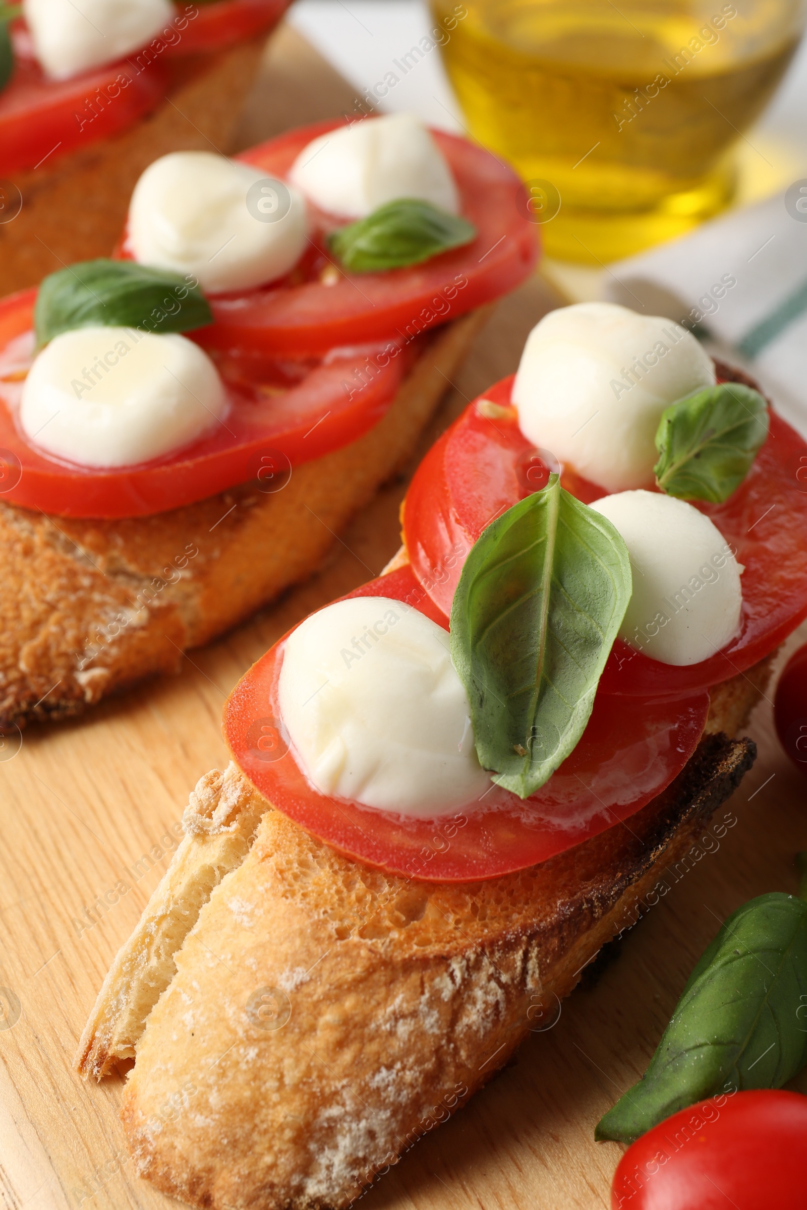 Tasty sandwiches with mozzarella cheese, tomatoes and basil on table, closeup Photo of Tasty sandwiches with mozzarella cheese, tomatoes and basil on table, closeup